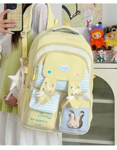 Close-up detail of cute canvas school backpack with ribbon bows and transparent bunny pocket.