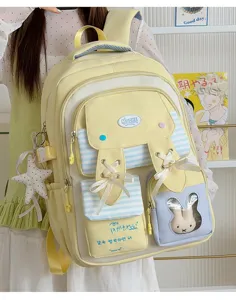 Cute yellow canvas school backpack with bunny ears, ribbons, and clear front pocket
