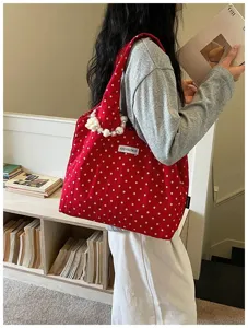 Chic red polka dot canvas shoulder bag with pearl handle, casual versatile underarm bag.
