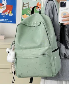 Detailed shot of casual starry print school backpack in light green, featuring cute furry pendant.