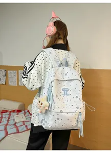 Backpack detail view showcasing star pattern, multiple compartments and cute star plush pendant.