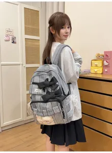 Detailed view of black white plaid backpack with big bows, cute transparent front pocket.