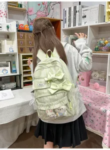 Green plaid backpack with bows and cute plush pendants, perfect for students and daily use.