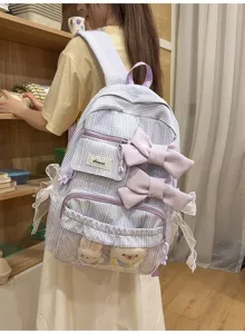 Detailed view of the cute plaid student backpack featuring lovely double bows and plush toys.