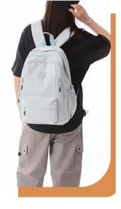 Detailed view of a light blue waterproof nylon backpack worn by a model, large capacity casual.