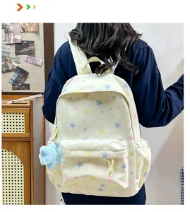 Cute pastel star print backpack with fluffy plush pendant, casual student school bag for daily commute.
