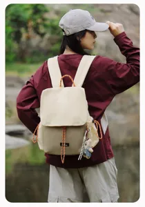 Casual outdoor canvas backpack with stylish drawstring design, perfect for hiking and daily use.