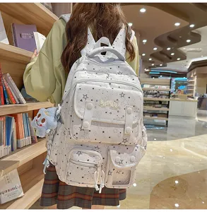 Stylish white star print backpack for students, casual daily travel school bag with pockets.
