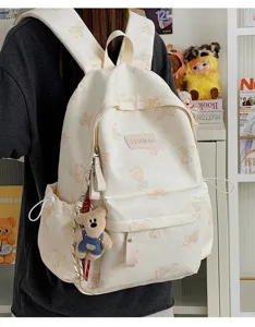 Cute bear print canvas backpack for daily commute, large capacity school bag with plush pendant.