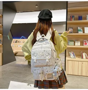 Stylish star printed canvas school backpack featuring multiple functional pockets and cute pendant.