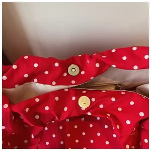Red white polka dot canvas shoulder bag detail interior view with magnetic snap closure.