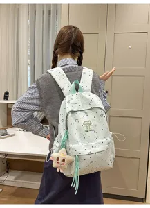 Backpack detail view showing mint star print design and multi-compartment student schoolbag
