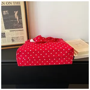 Red polka dot canvas shoulder bag detail view, casual lightweight tote bag for daily outfit styling.