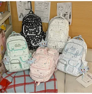 Detail view of cute starry school backpack with star plush pendant and multiple functional pockets.