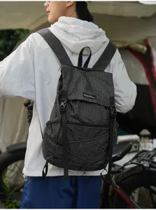 Details of the black grid outdoor backpack, lightweight design with adjustable straps.