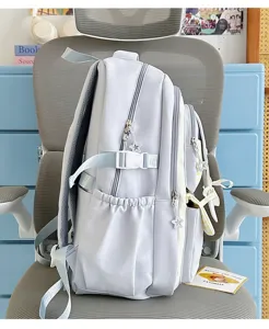 Cute pastel blue school backpack with ribbon bows and star charms, detailed daily use backpack