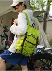 Lightweight folding outdoor backpack for hiking and travel, detail view of green fabric.