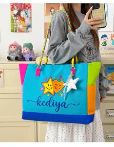 Colorful canvas tote bag detail view, dopamine color block design with braided straps.
