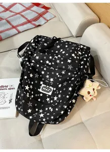 Detailed view of the black star-patterned backpack with multiple compartments and cute star pendant.