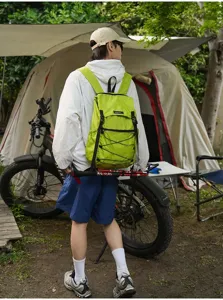 Outdoor view of the ultralight green foldable backpack in use, showing grid fabric.
