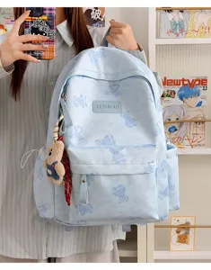 Detail shot of the cute tie-dye bear pattern backpack showcasing front pocket and cute pendant.