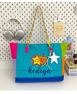 Detailed view of colorful patchwork dopamine canvas tote bag with braided handle and cute charms.