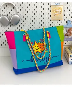 Detailed view of the colorful dopamine color-blocked canvas tote bag with braided straps.