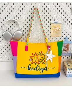 Detail view of colorful dopamine patchwork canvas tote bag with braided handle and cute star charm.