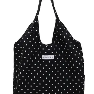 Black and white polka dot canvas shoulder bag, casual stylish underarm tote for women daily use.