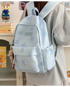 Cute bear print commuter backpack for men and women, stylish large capacity school bag detail.