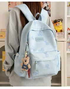 Detailed view of blue tie-dye backpack, featuring cute bear print and convenient side pockets.