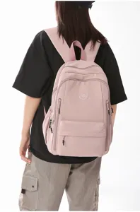 Detailed view of casual nylon backpack showing wearing effect on model, large capacity design.