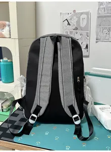 Casual student backpack detail showing black and white gingham straps and sweet lace trim.