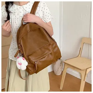 Sac à dos minimaliste en cuir PU marron de grande capacité pour les étudiants en voyage.
