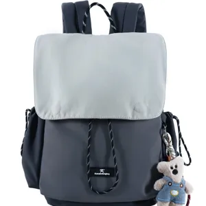 Grey two-tone casual backpack with drawstring and cute bear pendant, stylish school rucksack.
