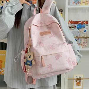 Pink tie-dye school backpack with cute bear print and pendant, large capacity casual daypack.