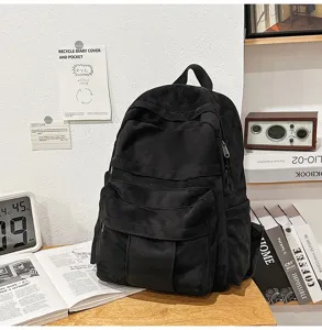 Lässiger schwarzer Wildleder-Rucksack mit mehreren Taschen für Pendeln und Freizeit.
