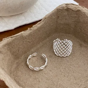 Detailed close-up of stylish silver mesh geometric and twisted open rings for daily wear.