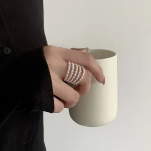 Exquisite multi-layer silver ring detail shot, stylish stacked finger jewelry for women daily wear.