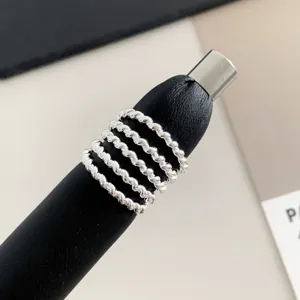 Silver multi-layer twisted rope ring close-up detail shot showing minimalist chic style