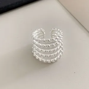 Multi-layer twisted rope silver ring, open adjustable design, trendy hip-hop style detail.