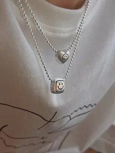 Double layer bead chain necklace with heart and square smiley pendants for women fashion.