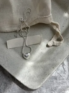 Exquisite brushed matte silver heart pendant necklace with delicate bead chain design for women.
