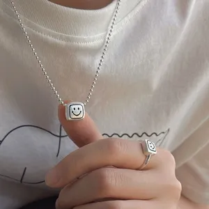 Silver beaded chain necklace with square smiling face pendant and matching ring for women trend.