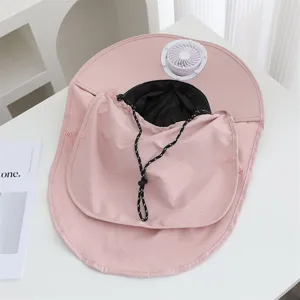 Close-up detail of the pink sun hat with built-in fan and breathable mesh lining for outdoor use.
