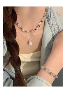 Detailed view of sweet blue heart layered necklace and matching bracelet, exquisite ins style.