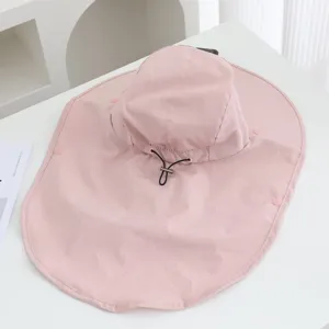 Detail view of the pink sun hat featuring breathable micro-perforations and adjustable cord.