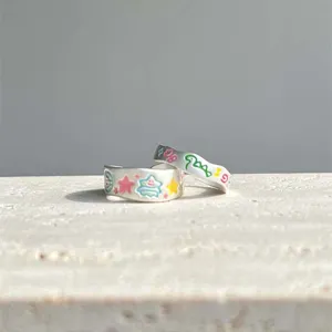 Open ring set featuring colorful graffiti enamel designs, cute cartoon style silver jewelry.