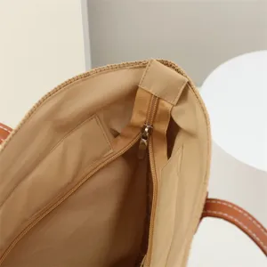 Detailed view of straw tote bag interior showing durable lining, zipper pocket and zip.