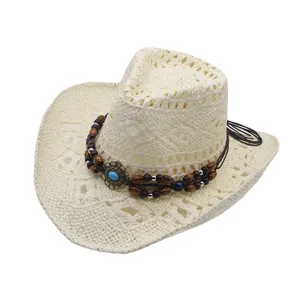Closeup of a woven straw western cowboy hat featuring wooden beads and turquoise decor detail.